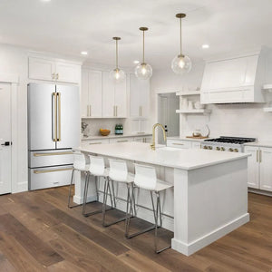 ZLINE Autograph Edition 36 in. 22.5 cu. ft Freestanding French Door Refrigerator with Ice Maker in Fingerprint Resistant Stainless Steel with Champagne Bronze Accents (RFMZ-36-CB) in a cottage-style kitchen with other ZLINE appliances and plumbing fixtures from side.