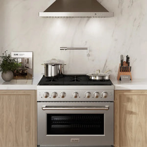 Luxury kitchen with a ZLINE 36 in. 5.2 cu. ft. Paramount Gas Range with Convection Gas Oven in Stainless Steel with 6 Brass Burners (SGR-BR-36), wooden cabinets, and a marble backsplash.