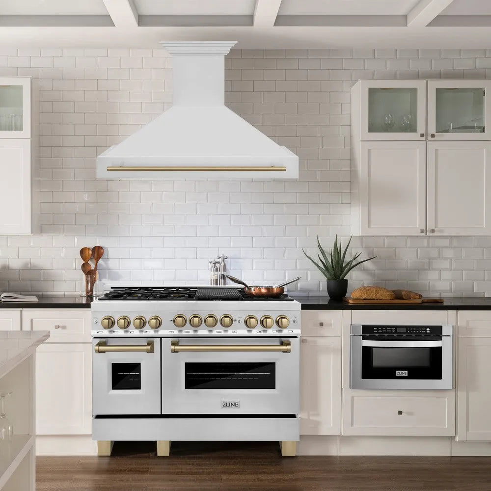 ZLINE Autograph Edition 48 in. Stainless Steel Range Hood with Stainless Steel Shell and Champagne Bronze Handle (8654STZ-48-CB) in a kitchen with matching range and cabinets