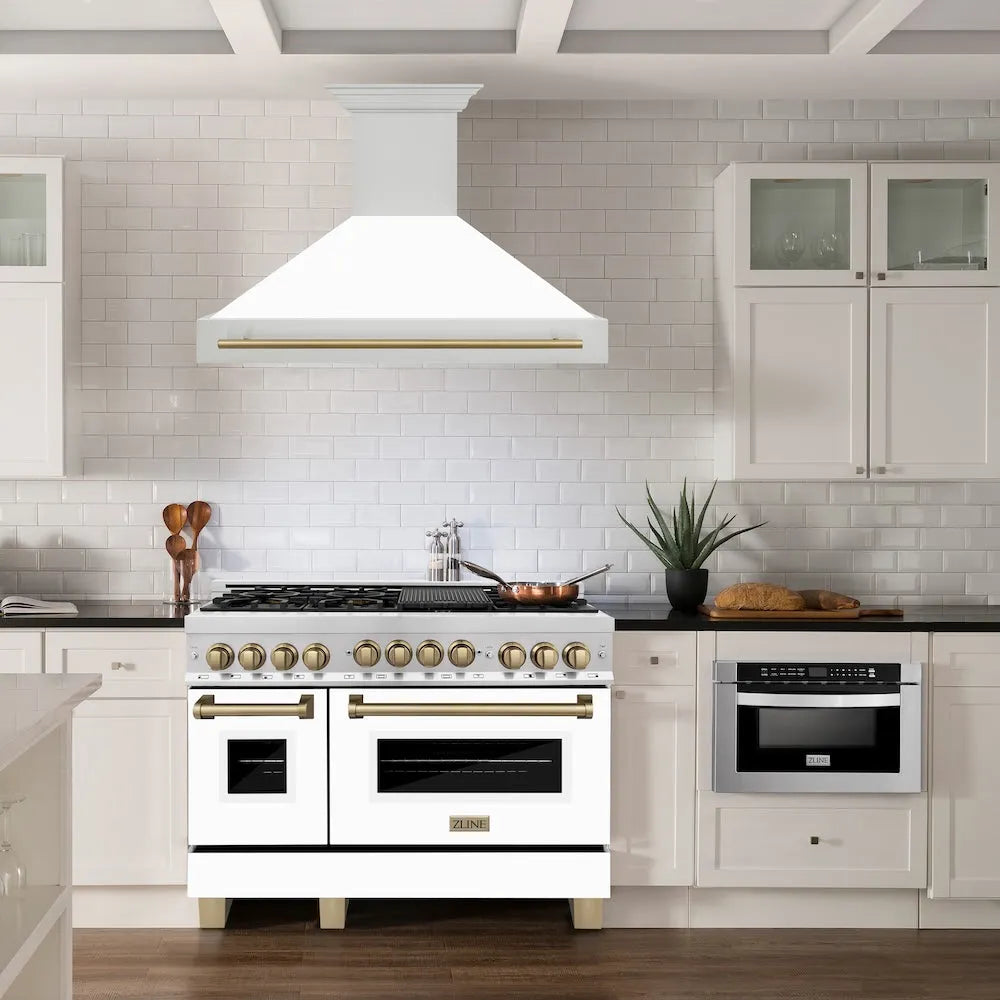 ZLINE Autograph Edition 48 in. Stainless Steel Range Hood with White Matte Shell and Champagne Bronze Handle (8654STZ-WM48-CB) in a luxury kitchen.