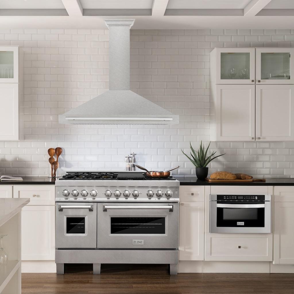 ZLINE Convertible Fingerprint Resistant DuraSnow® Stainless Steel Range Hood with Stainless Steel Handle (KB4SNX) in a luxury kitchen with matching range and microwave.