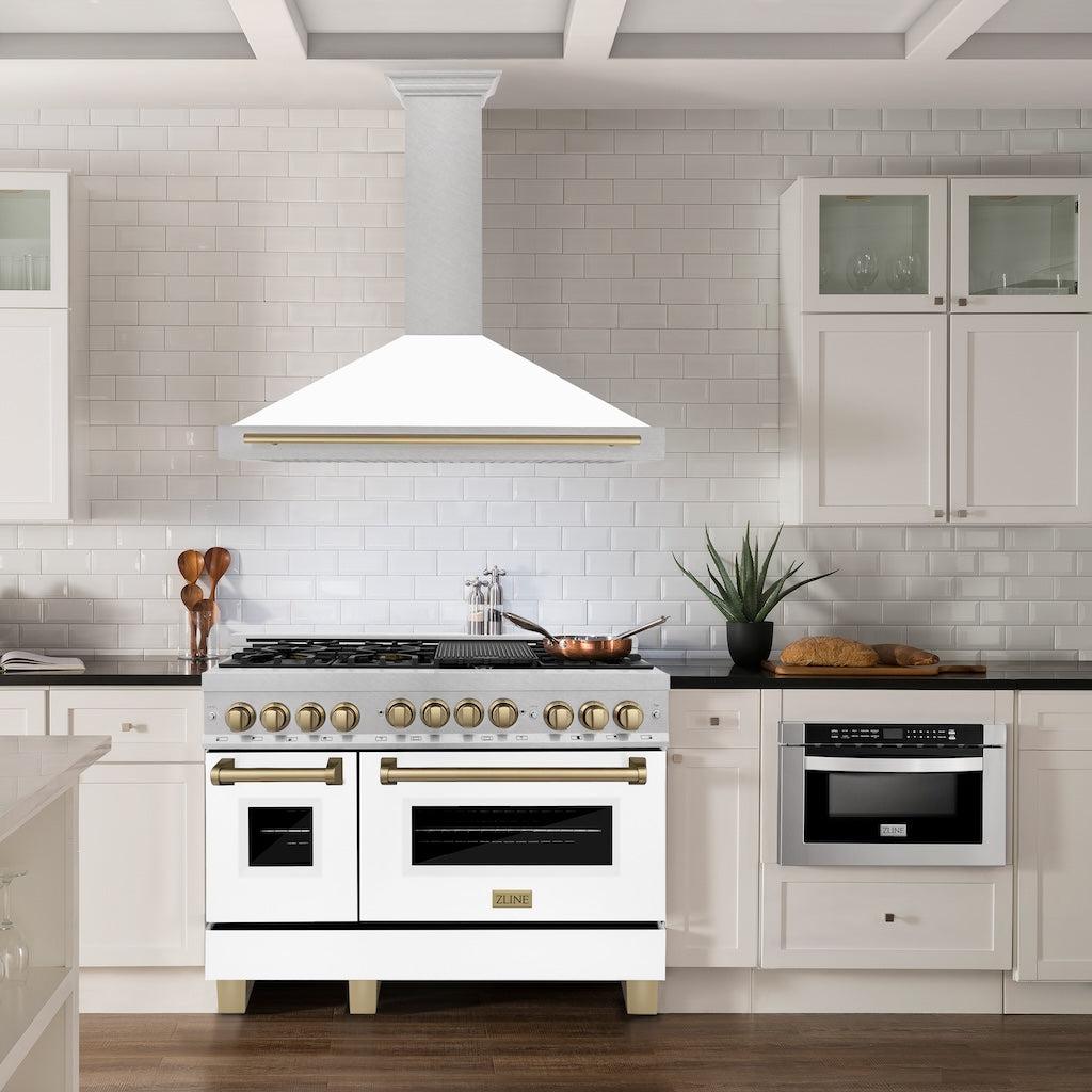 ZLINE Autograph Edition Convertible Fingerprint Resistant DuraSnow® Stainless Steel Range Hood with White Matte Shell and Champagne Bronze Handle (KB4SNZ-WM-CB) in a luxury kitchen with matching range and microwave.