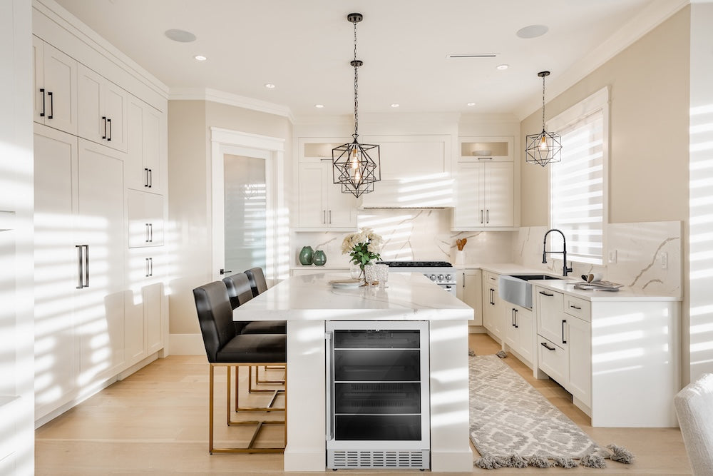 Modern kitchen with white cabinets, island, and ZLINE 24 in. Monument 154 Can Beverage Fridge in Stainless Steel (RBV-US-24).