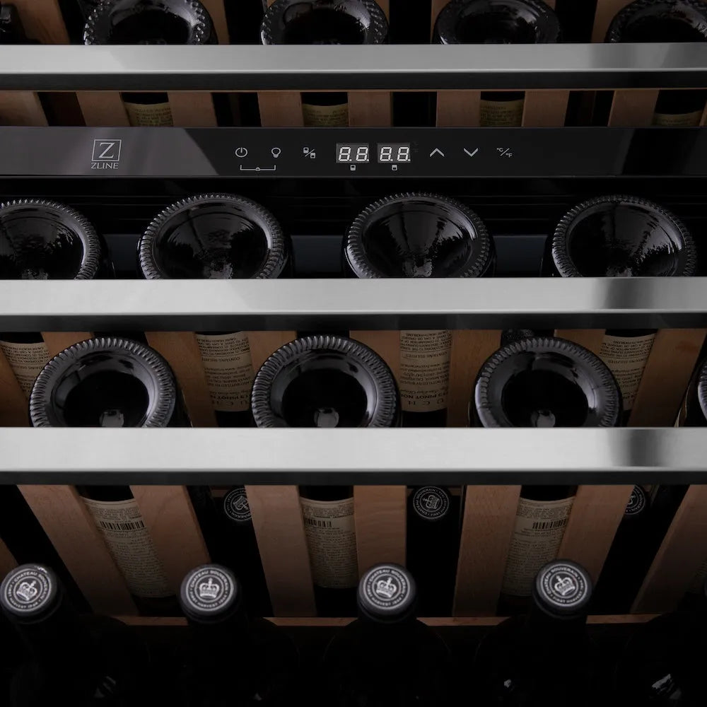 Wine bottles in a ZLINE Autograph Edition 24 in. Monument Dual Zone 44 Bottle Wine Cooler in Stainless Steel with Champagne Bronze Accents (RWVZ-UD-24-CB) with digital display.