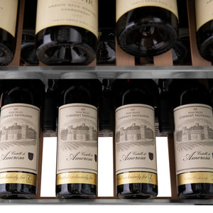 Wine bottles with labels on a shelf in ZLINE Autograph Edition 24 in. Monument Dual Zone 44 Bottle Wine Cooler in Stainless Steel with Champagne Bronze Accents (RWVZ-UD-24-CB)