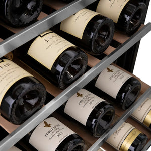 Wine bottles arranged in a ZLINE Autograph Edition 24 in. Monument Dual Zone 44 Bottle Wine Cooler in Stainless Steel with Champagne Bronze Accents (RWVZ-UD-24-CB) with visible labels.
