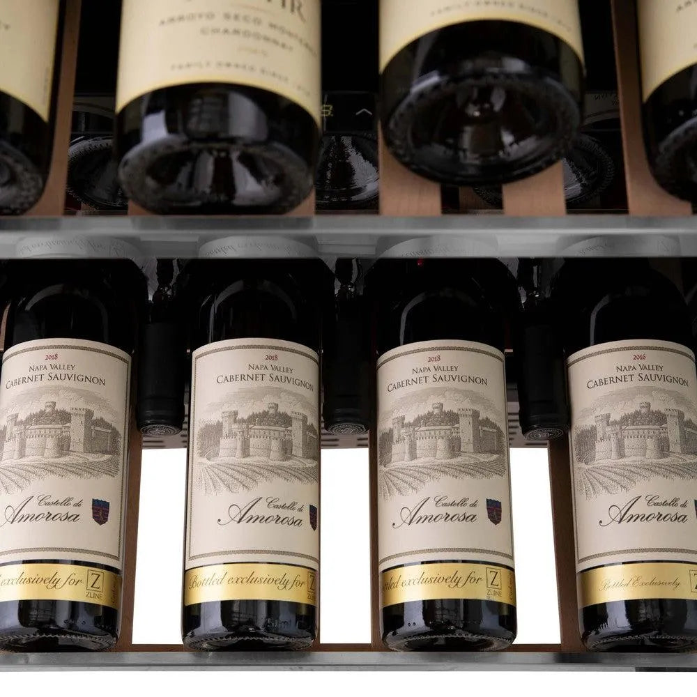 ZLINE Autograph Edition 24 in. Monument Dual Zone 44-Bottle Wine Cooler in Stainless Steel with Matte Black Accents (RWVZ-UD-24-MB) close-up, four bottles of Cabernet Sauvignon on an extended wood shelf from above.