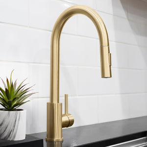 ZLINE Palisades Pull Down Single Handle Kitchen Faucet in Champagne Bronze (RBCN1-KF-CB) with a plant on a counter against a tiled wall.