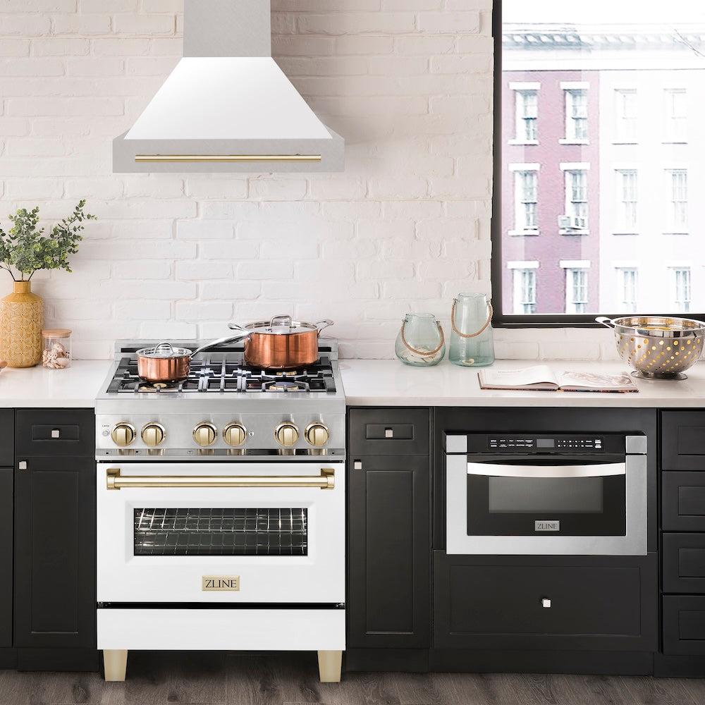 ZLINE Autograph Edition 30 in. Satin Stainless Steel Wall Mount Range Hood with White Matte Shell and Polished Gold Handle (8654SNZ-WM30-G) in a luxury kitchen.