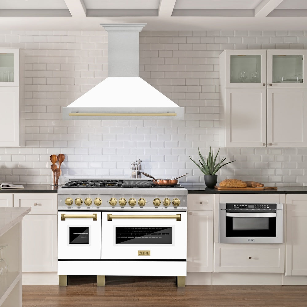 ZLINE Autograph Edition 48 in. Satin Stainless Steel Wall Mount Range Hood with White Matte Shell and Champagne Bronze Handle (8654SNZ-WM48-CB) in a luxury kitchen.
