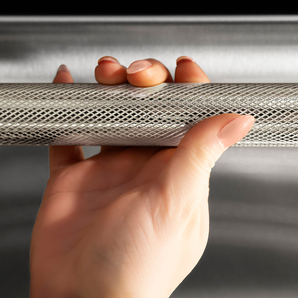 ZLINE Autograph Edition 24 in. Monument Series 3rd Rack Top Touch Control Tall Tub Dishwasher in Stainless Steel with Polished Nickel Helix Handle, 45dBa (DWMTZ-30424-KPN) hand holding Helix handle showing knurled diamond texture.