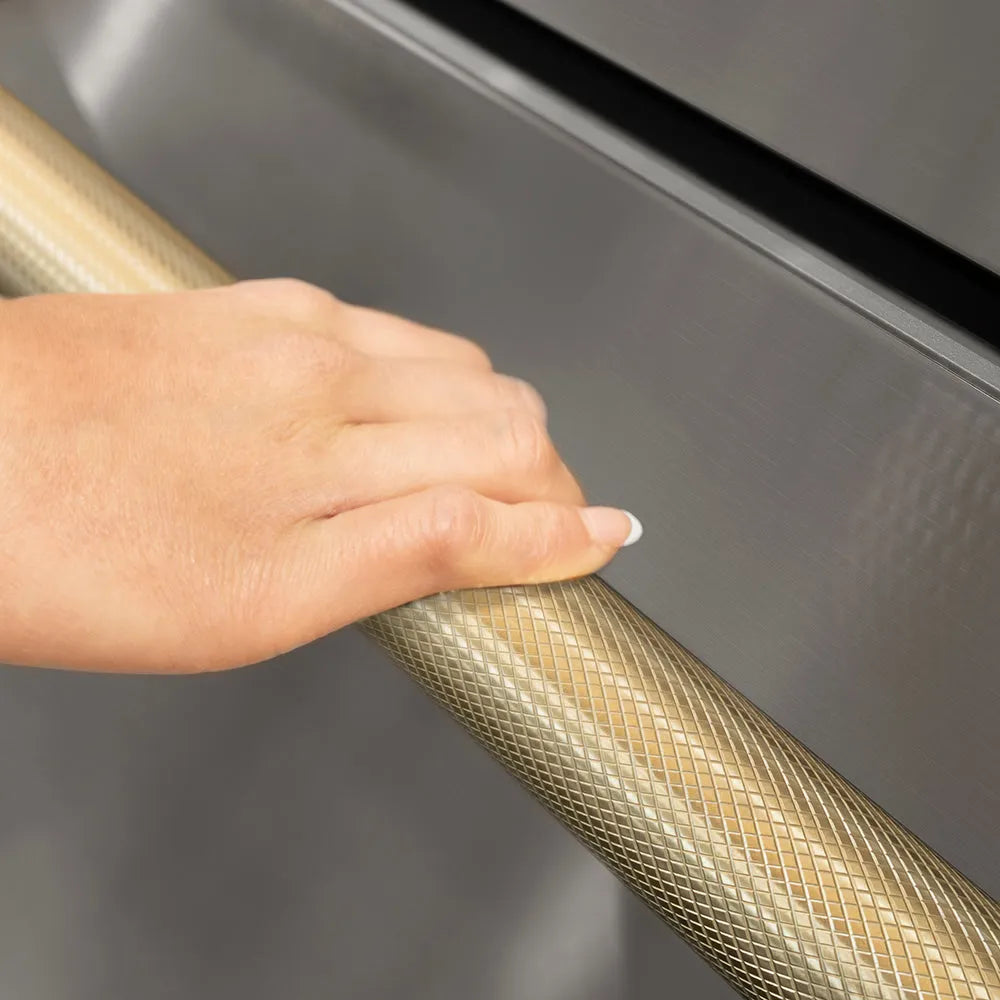 ZLINE Autograph Edition 24 in. Touchstone 168 Can Outdoor-Rated Dual Refrigerator Drawer with Stainless Steel Doors and Champagne Bronze Helix Handles (RDSOZ-ST-24-KCB) hand holding Helix handle showing knurled diamond texture.
