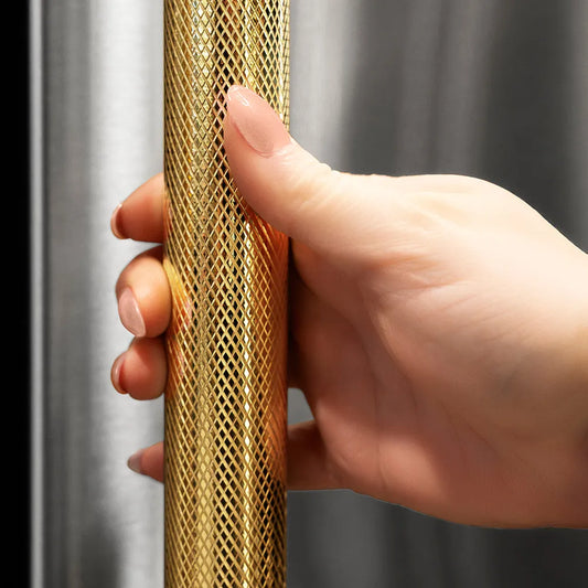 ZLINE Autograph Edition 36 in. 19.6 cu. ft. French Door Built-In Bottom Freezer Refrigerator with Water Dispenser and Ice Maker in Stainless Steel with Graphite Gray Interior and Polished Gold Helix Handles (GRBIVZ-30436KG) hand holding Helix handle showing knurled diamond texture.