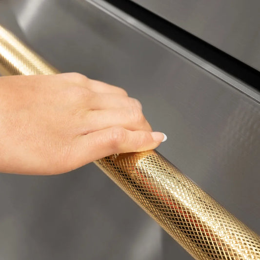 ZLINE Autograph Edition 24 in. Touchstone 168 Can Outdoor-Rated Dual Refrigerator Drawer with Stainless Steel Doors and Polished Gold Helix Handles (RDSOZ-ST-24-KG) hand holding Helix handle showing knurled diamond texture.