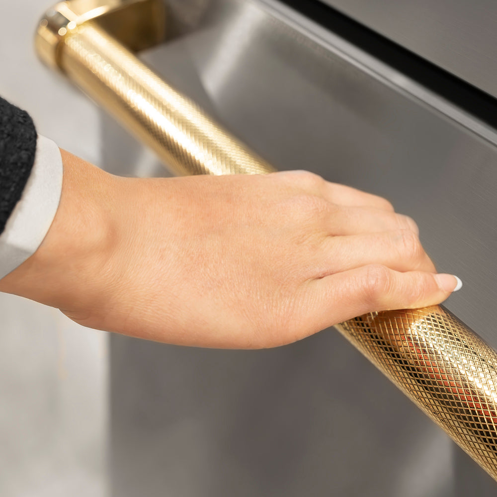 ZLINE Autograph Edition 60 in. 32.2 cu. ft. French Door Built-In Bottom Freezer Refrigerator with Water Dispenser and Ice Maker in Stainless Steel with Graphite Gray Interior and Polished Gold Helix Handles (GRBIVZ-30460KG) hand holding Helix handle showing knurled diamond texture.