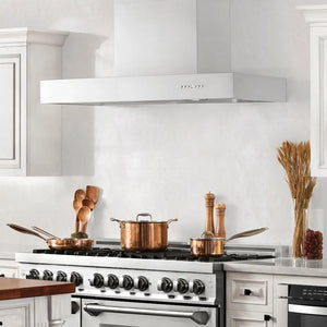Farmhouse kitchen with ZLINE 36 in. Ducted Professional Wall Mount Range Hood in Stainless Steel (KECOM-36) above a stainless steel range with copper pots on the cooktop.