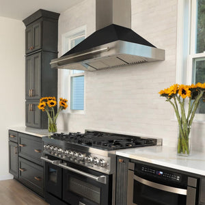 ZLINE Convertible Stainless Steel Range Hood with Black Matte Shell and Stainless Steel Handle (KB4STX-BLM) in a luxury kitchen with matching range and microwave.