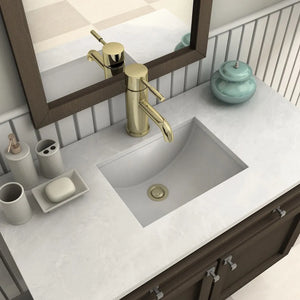 ZLINE Autograph Edition Aloha Single Handle Bath Faucet in Polished Gold (ALH-BF-PG) on a bathroom vanity with mirror and toiletries.
