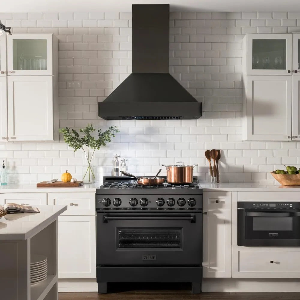 ZLINE 36 in. Ducted Vent Black Stainless Steel Wall Mount Range Hood (BS655N-36) in a kitchen with a black range against a white tiled wall.