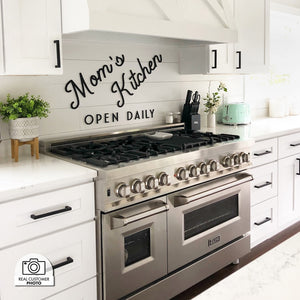 Farmhouse kitchen with stainless steel oven, decorative wall art, and a custom range hood using a ZLINE 46 in. Ducted Wall Mount Range Hood Insert in Stainless Steel (698-46).
