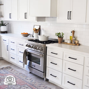 Cottage kitchen with white cabinets, stainless steel oven, decorative elements, and a custom range hood using ZLINE 46 in. Ducted Wall Mount Range Hood Insert in Stainless Steel (698-46)