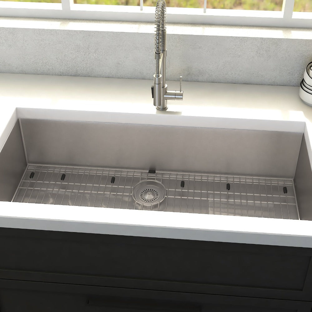 ZLINE Meribel 33 in. Undermount Single Bowl Stainless Steel Kitchen Sink with Bottom Grid (SRS-33) in a farmhouse-style kitchen, close-up.