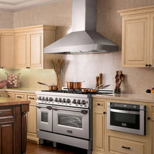 Stainless steel range and ZLINE 42 in. Professional Convertible Vent Wall Mount Range Hood in Stainless Steel with Crown Molding (597CRN-42) in a kitchen with beige cabinets and wooden island.
