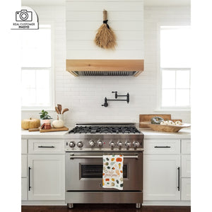 Farmhouse kitchen with stainless steel range, white cabinets, decorative elements, and a custom shiplap range hood using aZLINE 46 in. Ducted Wall Mount Range Hood Insert in Stainless Steel (698-46).