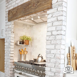 Farmhouse kitchen with white brick wall, stainless steel range, and a custom range hood using a ZLINE 46 in. Ducted Wall Mount Range Hood Insert in Stainless Steel (698-46).