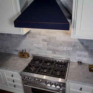 ZLINE Designer Series Wall Mount Range Hood in Oil-Rubbed Bronze (8667B) above, in a luxury white kitchen.