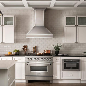 ZLINE Designer Series Wall Mount Range Hood in Fingerprint Resistant Stainless Steel with Mirror Accents (655MR) in White Farmhouse Kitchen with Matching ZLINE Range and ZLINE Microwave