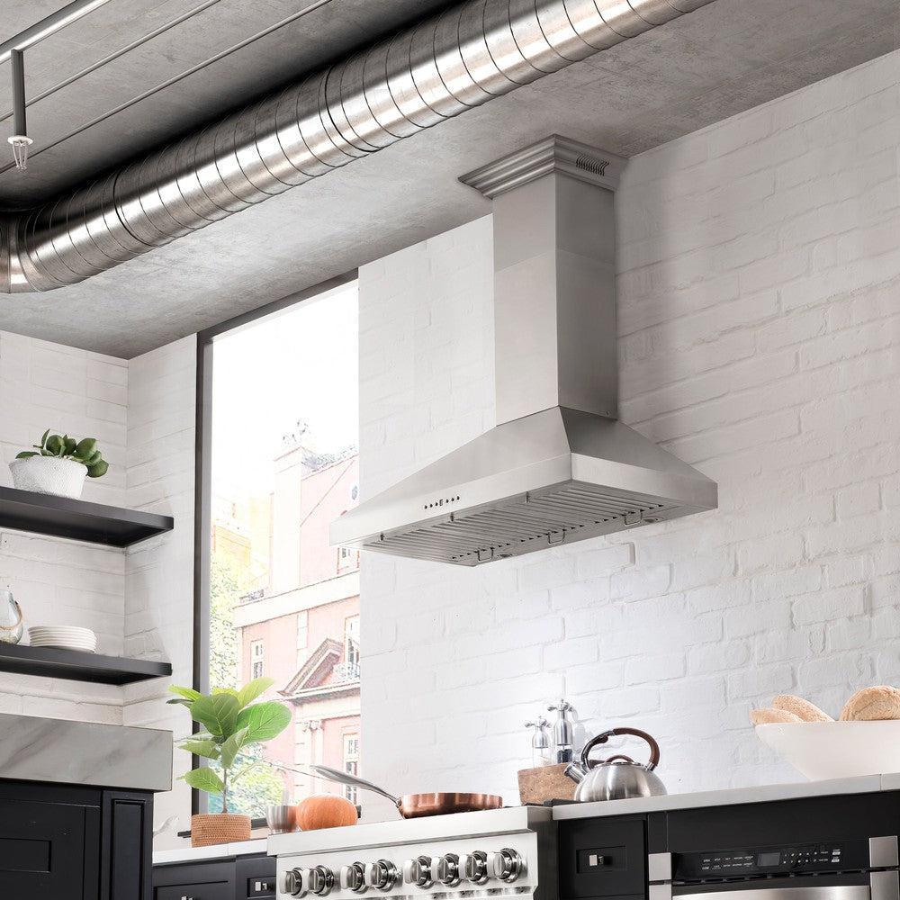 ZLINE Ducted Vent Wall Mount Range Hood in Stainless Steel with Built-in ZLINE CrownSound Bluetooth Speakers (KL3CRN-BT) in a luxury compact kitchen with matching range and microwave, front.