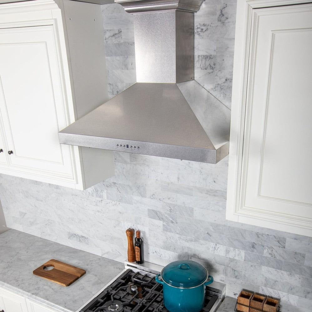 ZLINE Wall Mount Range Hood in Fingerprint Resistant Stainless Steel (8KL3S) in a white kitchen.