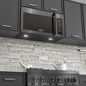 ZLINE Black Stainless Steel Over the Range Microwave in a modern kitchen above cooktop with lighting on.