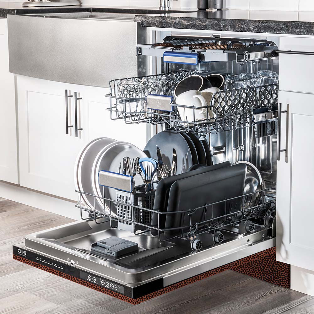 ZLINE 24 in. Tallac Series 3rd Rack Dishwasher with Hand-Hammered Copper Panel and Traditional Handle, 51dBa (DWV-HH-24) side, open, in a luxury kitchen with dishes loaded on racks.