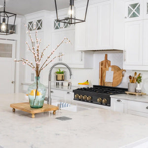 ZLINE Autograph Edition 36 in. Legacy Gas Rangetop with 6 Burners and Porcelain Cooktop in Black Stainless Steel with Champagne Bronze Accents (RTBZ-36-CB) lifestyle, in a luxury kitchen.