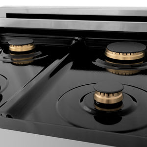 ZLINE Autograph Edition 24 in. 2.8 cu. ft. Legacy Dual Fuel Range with 4 Burner Gas Cooktop and Electric Convection Oven in Stainless Steel with White Matte Door and Matte Black Accents (RAZ-WM-24-MB) brass burners on black porcelain cooktop no grates.