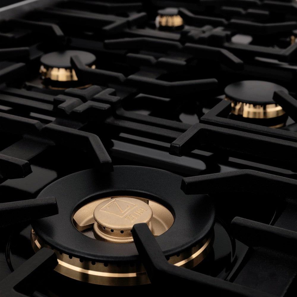 ZLINE brass burners on black porcelain cooktop with cast-iron grates.