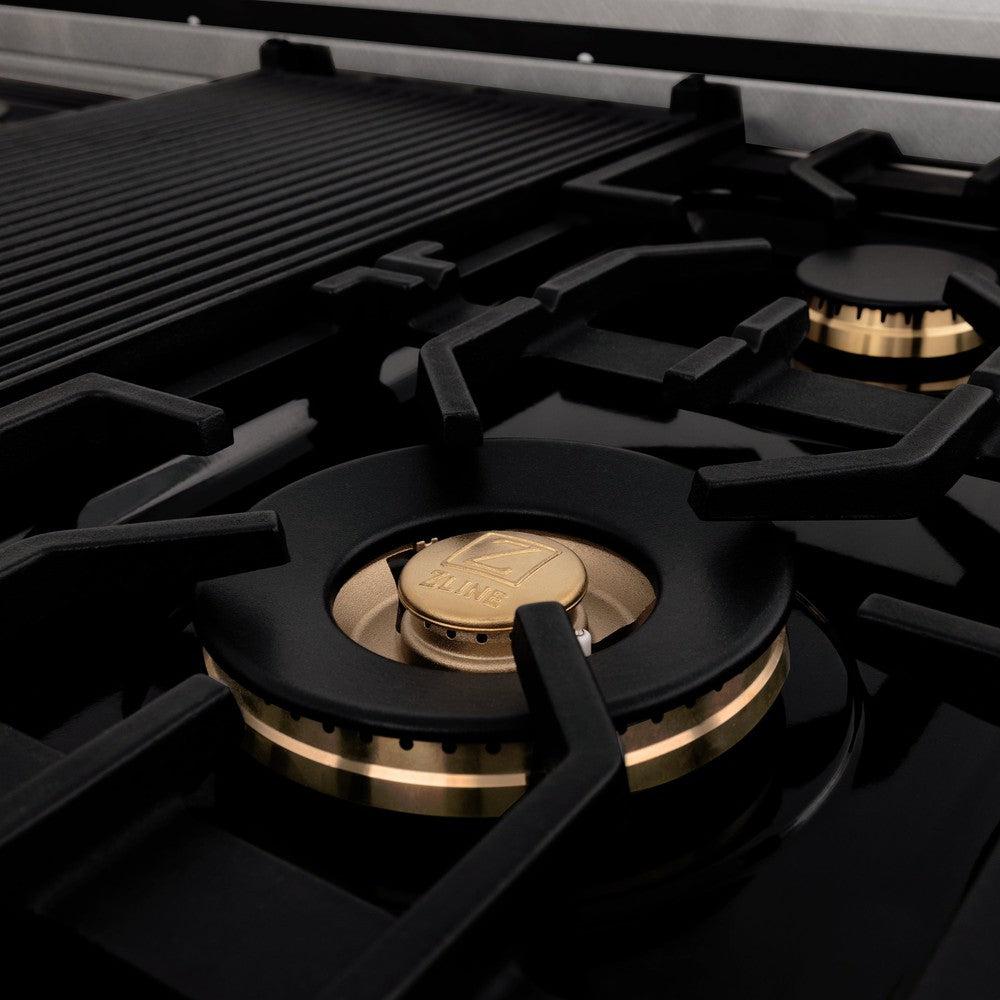 ZLINE brass burners with continuous cast-iron grates close up.