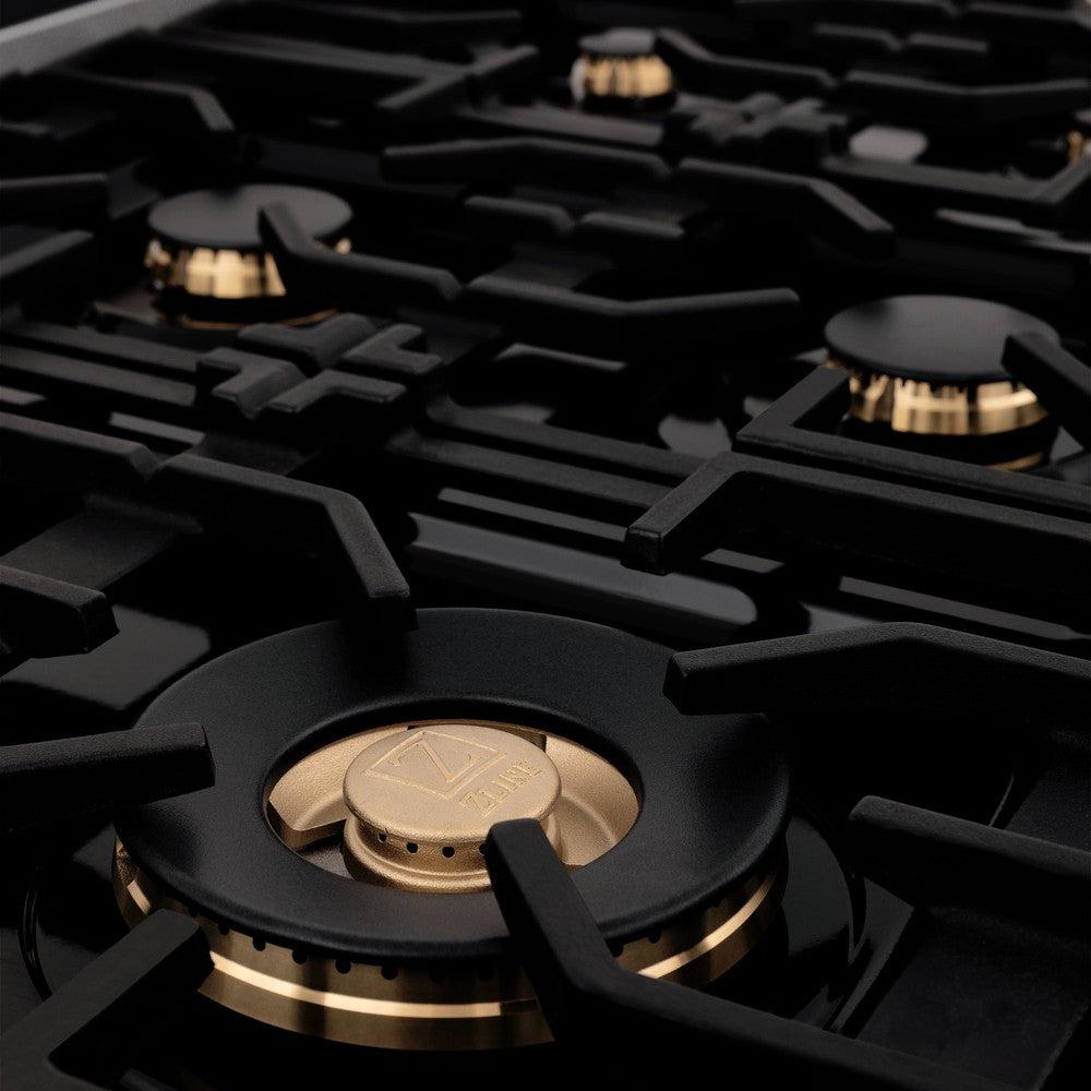 ZLINE brass burners on black porcelain cooktop with cast-iron grates.