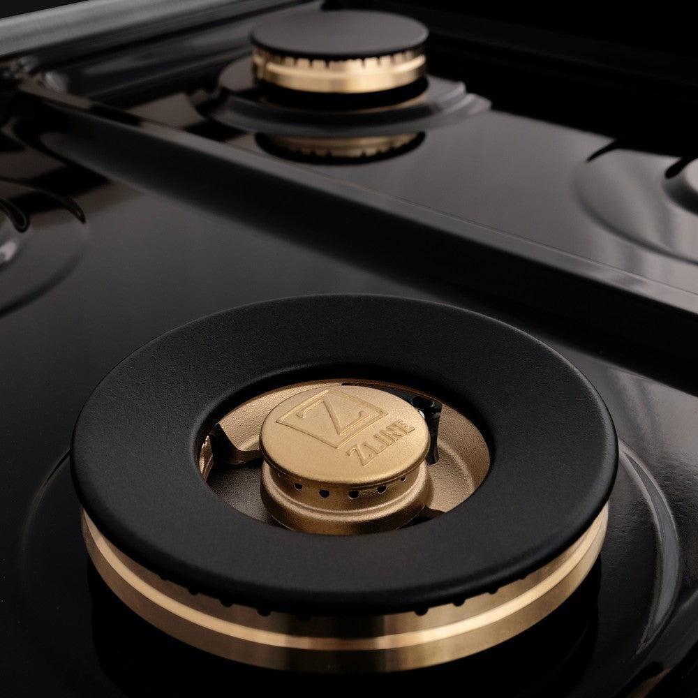 ZLINE brass burners and black porcelain cooktop close up.