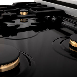 Three ZLINE brass burners on black porcelain cooktop without grates.