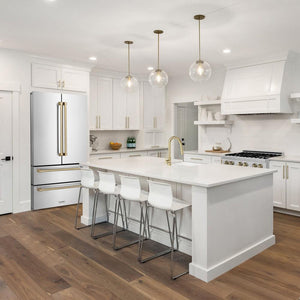 ZLINE Autograph Edition 36 in. 22.5 cu. ft Freestanding French Door Refrigerator with Ice Maker in Fingerprint Resistant Stainless Steel with Champagne Bronze Accents (RFMZ-36-CB) in a cottage-style kitchen with other ZLINE appliances and plumbing fixtures from side.