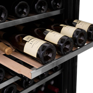 ZLINE Autograph Edition 24 in. Monument Dual Zone 44-Bottle Wine Cooler in Stainless Steel with Matte Black Accents (RWVZ-UD-24-MB) close-up, four bottles of Chardonnay on an extended wood shelf from front.