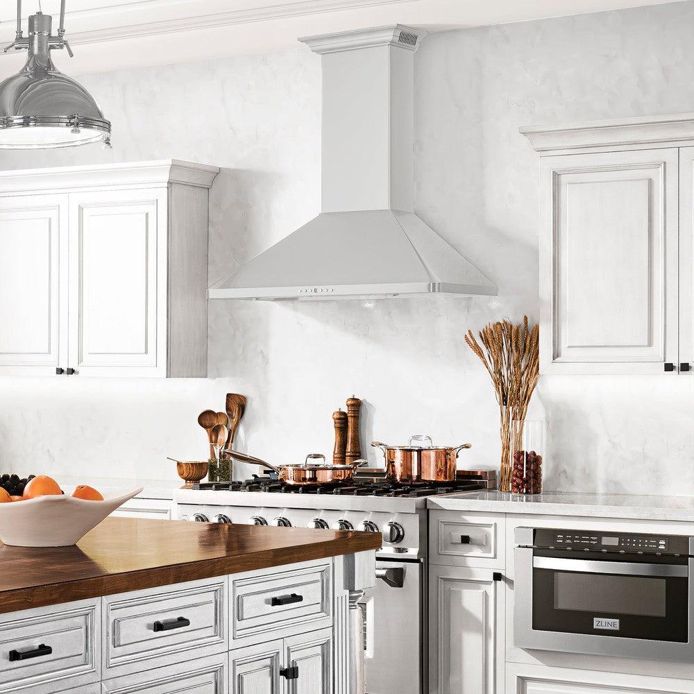 ZLINE Wall Mount Range Hood in Stainless Steel with Built-in CrownSound Bluetooth Speakers (KF1CRN-BT) in a white cottage-style kitchen, front.