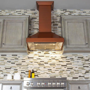 ZLINE Convertible Designer Series Copper Wall Mount Range Hood (8667C) above a range in a kitchen.