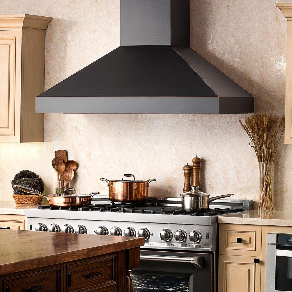 ZLINE Designer Series Wall Mount Range Hood in Oil-Rubbed Bronze (8667B) in a farmhouse-style kitchen close-up.