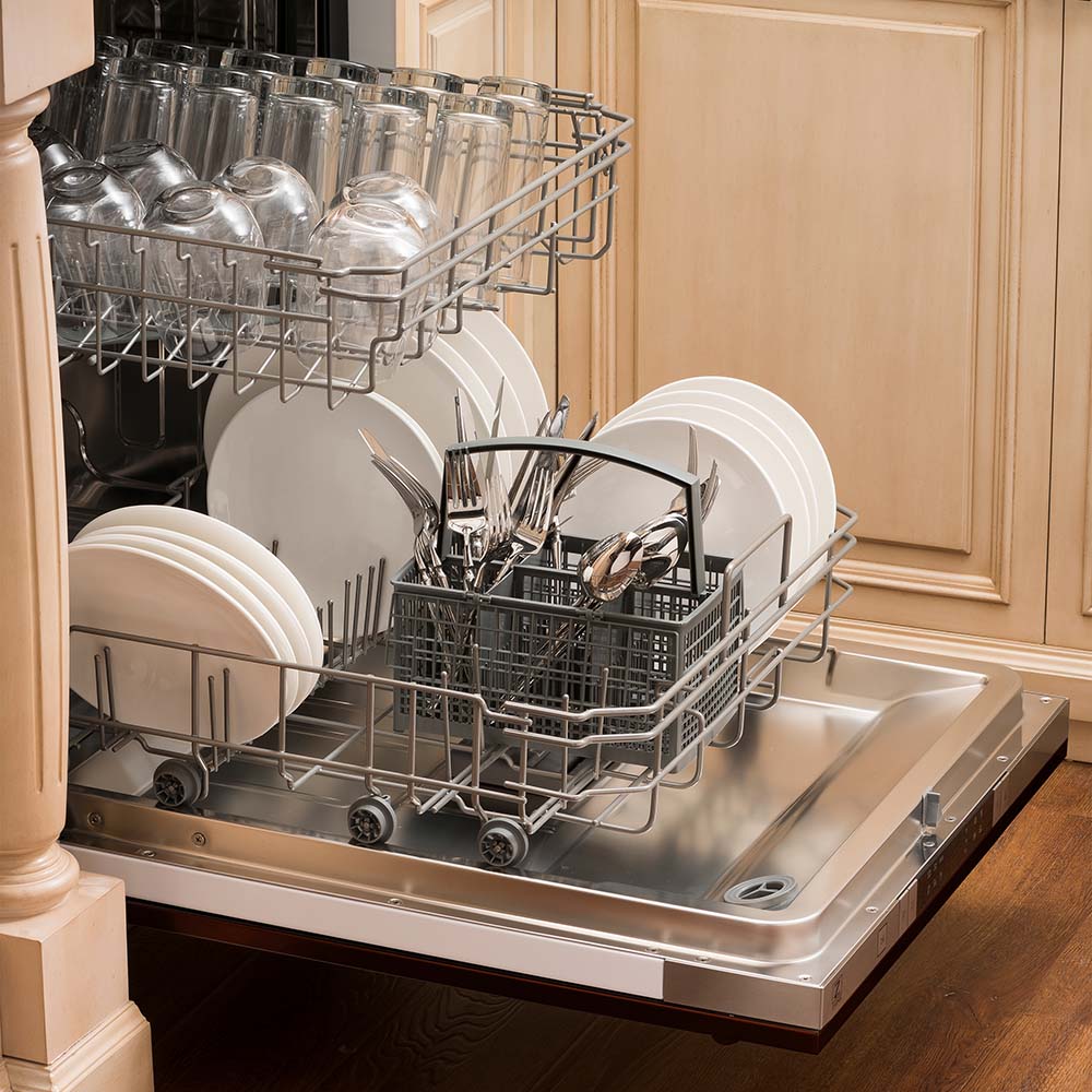 Built-in top control dishwasher with dishes and utensils on bottom rack and glassware on top rack