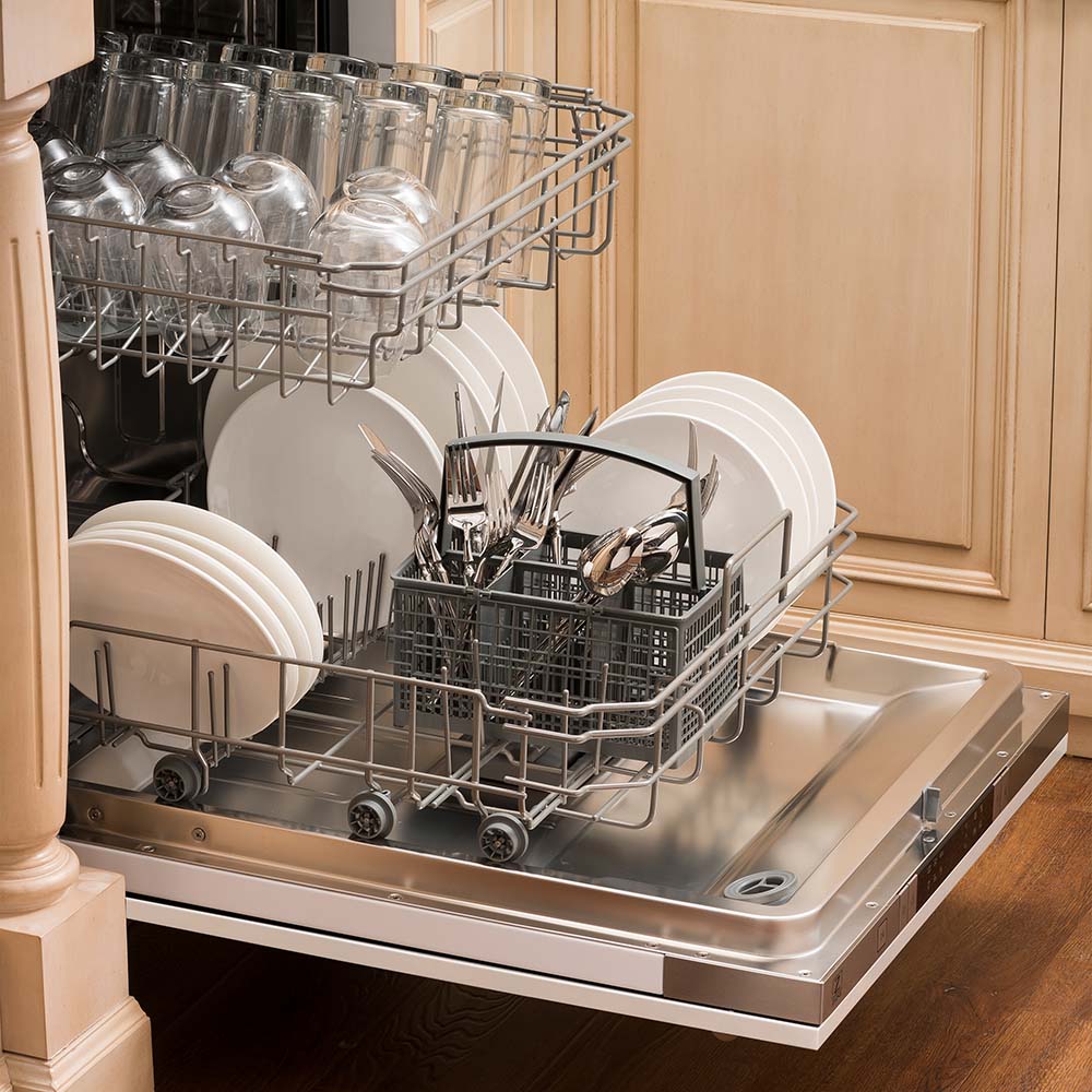 Built-in top control dishwasher with dishes and utensils on bottom rack and glassware on top rack