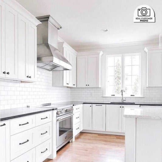 ZLINE Professional Convertible Vent Wall Mount Range Hood in Stainless Steel (587) in a white cottage-style kitchen.